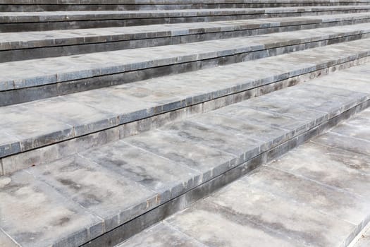 Photo broad steps made of concrete. Color gray structure, photographed at an angle and are visible plate