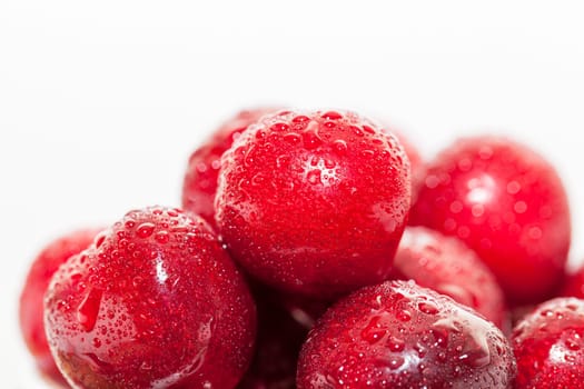 Photographed close-up ripe red cherries covered with drops of water, little depth of field