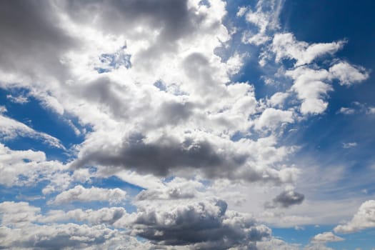 bright cumulus clouds are in the background of blue sky, close-up