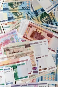 photographed close-up of the Belarusian money lying in a large pile of old and new banknotes