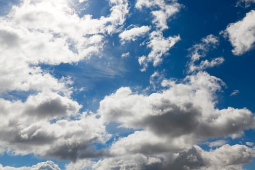 bright cumulus clouds are in the background of blue sky, close-up