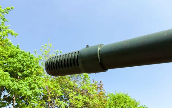 photographed close-up of the gun barrel, situated on an old military equipment. tank for fighting
