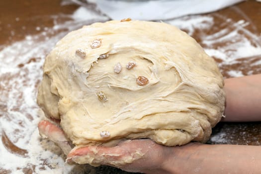 close-up dough for baking a cake at home, the woman's hand can be seen