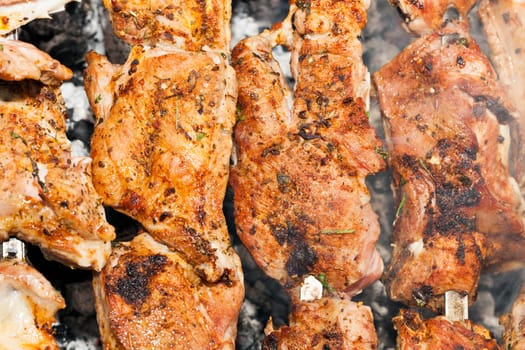 photographed close-up of pork meat pieces while cooking barbecue