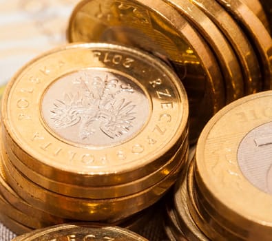 photograph taken close-up, which shows the Polish coin lying on the paper money. Zloty, a small depth of field