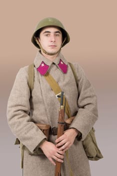 young Soviet soldier with winter uniform and rifle