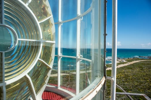 A view to the most Southern point of Africa from the top of a lighthouse with part of the light in view.