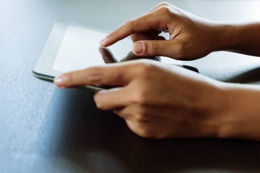 close-up hand using tablet, selective focus finger touching on tablet display