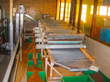 Nuvara Eliya, Sri Lanla - May 03, 2009: The tables and bags with tea leaf crop on Mackwoods Limited PVT tea factory for weighing in Nuwara Eliya, Sri Lanka at May 03, 2009.