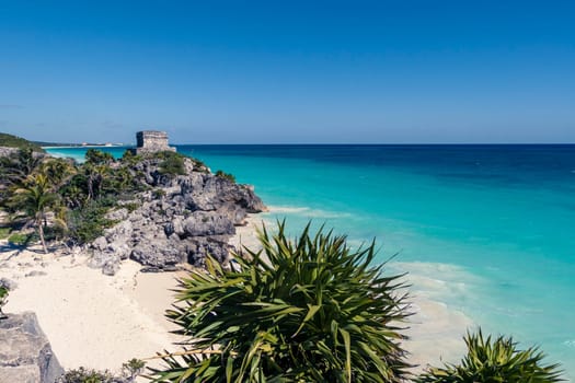Beautiful beach with turquoise water in Tulum Mexico, Mayan ruins on top of the cliff.