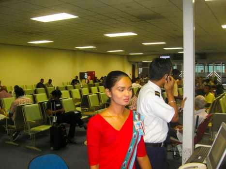 Colombo, Sri Lanka - May 05, 2009: The Young beautiful flight attendant in the Transit area at Bandaranaike International Airport at Colombo, Sri Lanka at May 05, 2009