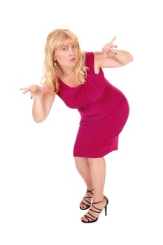 A lovely woman in a red dress standing isolated for white .background gesturing with her hands..