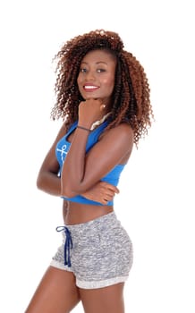 A beautiful young African American woman in shorts standing in profile.isolated for white background..