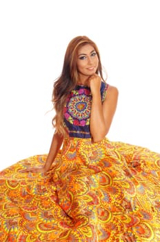 A lovely young woman in a yellow skirt sitting on the floor, isolated.for white background..