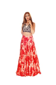 A beautiful Caucasian woman standing isolated for white background.in a long red skirt and black top..