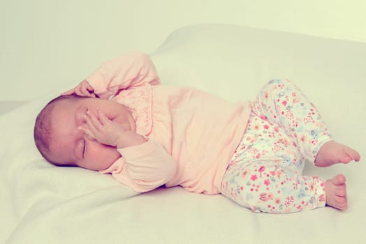sweet baby lying on bright ground