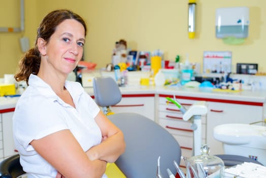 female dentist in dental surgery looking in to the camera