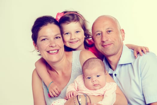 young happy family in front of white background