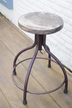 Old wooden outdoor chair on the floor, stock photo