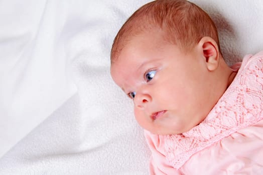 sweet baby lying on bright ground