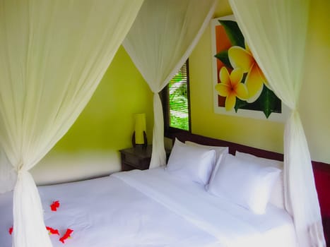 Bali, Indonesia - April 13, 2012: View of bungalow with bed at Nandini Bali Jungle Resort and Spa.