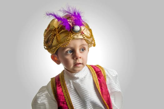Child posing in sultan costume.