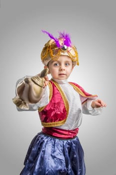 Child in sultan costume with lamp.