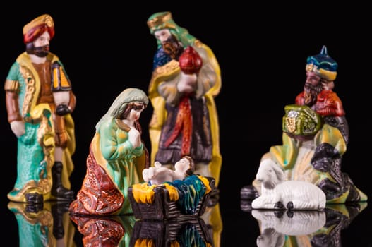 Christmas Manger scene with figurines including Jesus, Mary and magi. Focus on Mary!