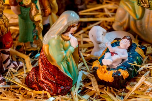 Christmas Manger scene with figurines including Jesus and Mary. Focus on baby Jesus!