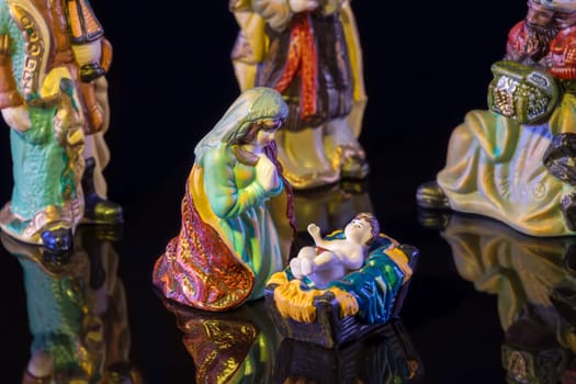 Christmas Manger scene with figurines including Jesus, Mary and magi. Focus on Mary!