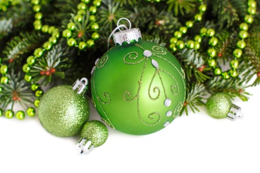 Green Christmas ornaments border on white background
