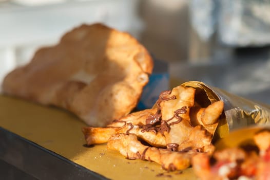 Street food. Sweet pancakes with chocolate. Selective focus.