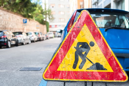Road signs in a street under reconstruction symbol.