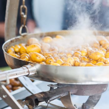 New potatoes. Fried in a pan. Italian recipe: potatoes cooked to Salento. Selective focus.