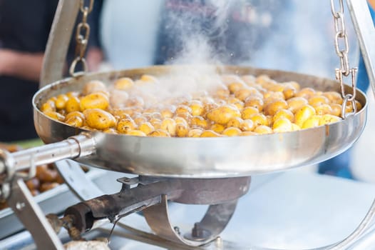 New potatoes. Fried in a pan. Italian recipe: potatoes cooked to Salento. Selective focus.