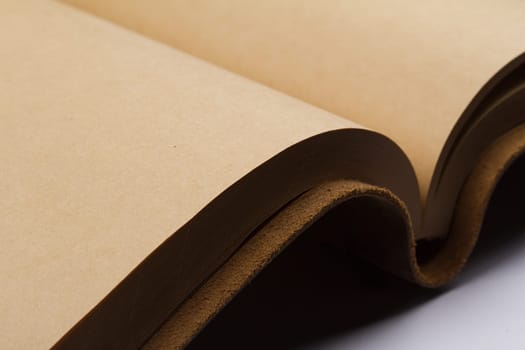 close up of empty pages of a leather covered book binding