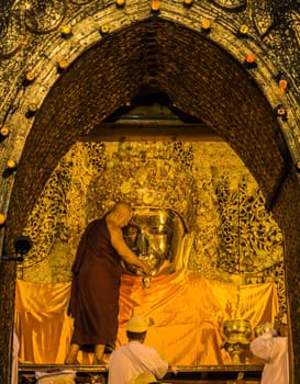 The ritual of daily face washing Mahamuni Buddha in Mandalay, Myanmar