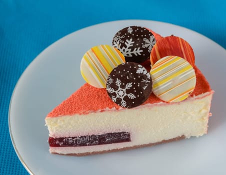 Floating Raspberry White Chocolate Mousse with chocolate coin topping on blue fabric background