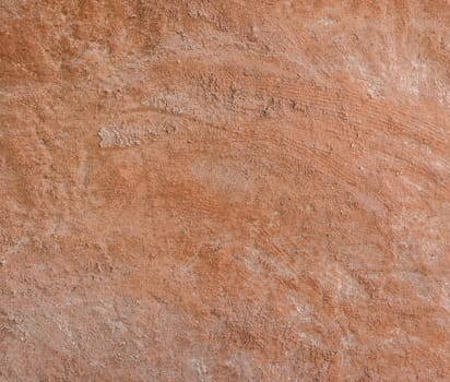Red natural wall texture of cob house for background. It is a natural building material made from subsoil, water and straw fibrous organic material.