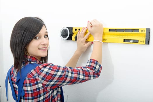 young brunette woman using spirit level
