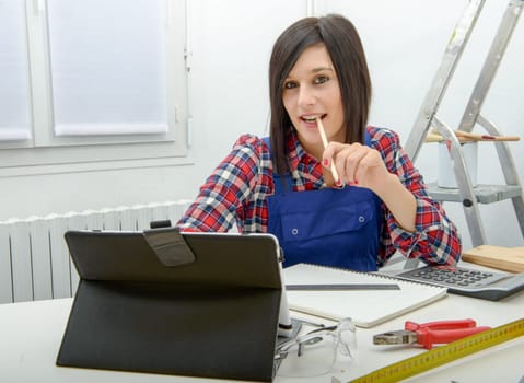 smiling attractive young woman using the tablet for DIY