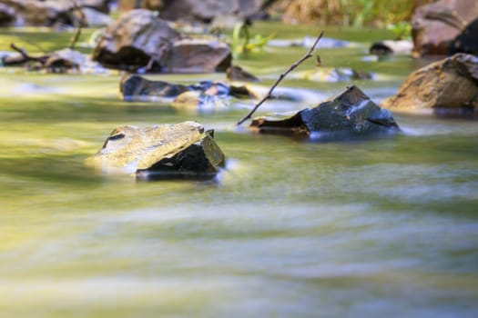 The stream washes the stones shot with slow shutter speed