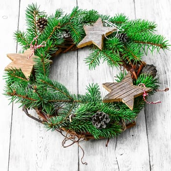 Noel wreath of fir branches decorated with Christmas toys