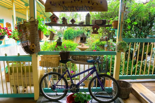 SALENTO, COLOMBIA - JUNE 6: Bicycle under welcome sign in a lush green garden in Salento, Colombia on June 6, 2016