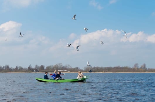 GIETHOORN, NETHERLANDS - APRIL 3, 2016: Unknown family enjoying their boating trip around Giethoorn, also called the Venice of the north