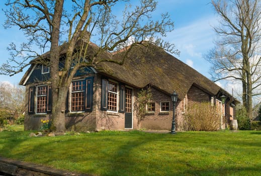 typical dutch country house with straw roofing in Giethoorn, the Netherlands
