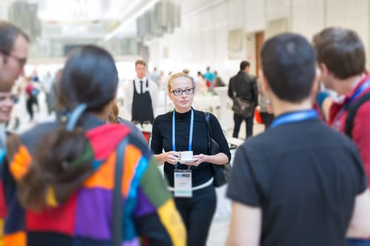 People interacting during coffee break at medical or scientific conference.
