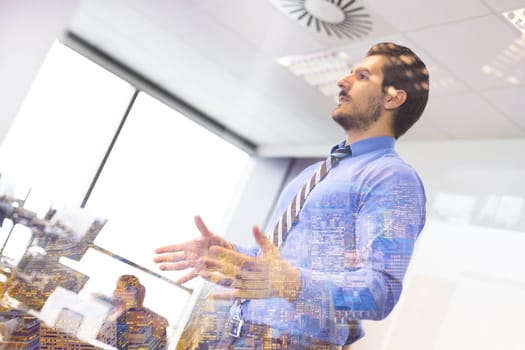 Business man making a presentation at office. Business executive delivering a presentation to his colleagues during meeting or in-house business training. Business and entrepreneurship.