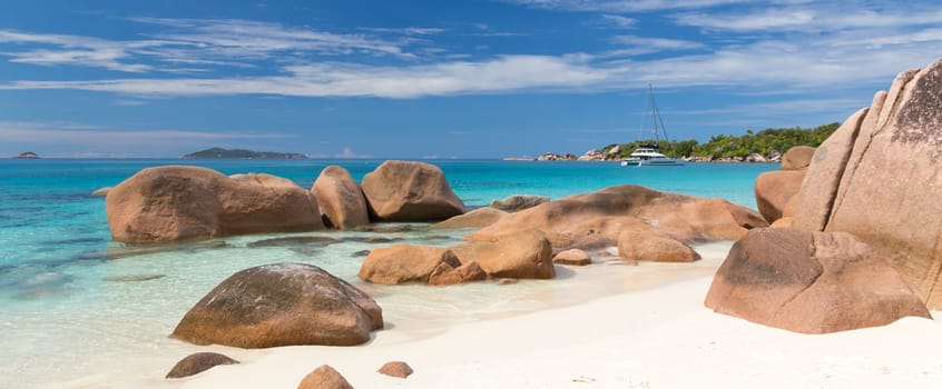 Catamaran boat on picture perfect tropical bay of Anse Lazio beach on Praslin Island, Seychelles.