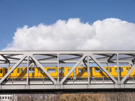 a train on a bridge in berlin in spring time
